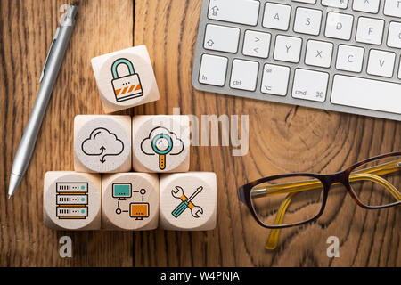 cube with icons smybolizing "cloud software" on wooden background Stock Photo
