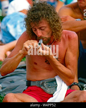 Saugerties, New York, USA, August, 1994Man lights up a pipe of marijuana at the Woodstock ’94 festival Credit:  Mark Reinstein / MediaPunch Stock Photo