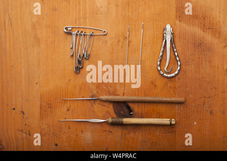 crochet tools, needles, safety pin and tailor tools  craft concept on wooden texture Stock Photo