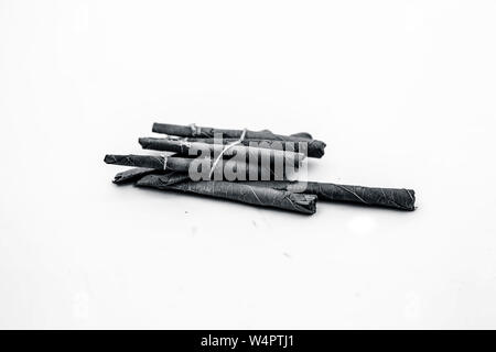 Close up of bidi or thin cigar or small cigarette isolated on white. Stock Photo