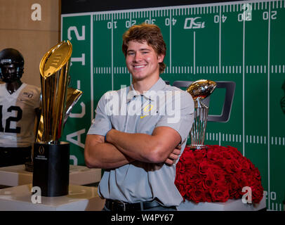 Hollywood, CA. 24th July, 2019. Oregon Ducks quarterback Justin Herbert poses for a photo in front of the Rose Bowl and National Championship trophies at the Pac-12 football media day on Wednesday, July 24, 2019 at the Hollywood and Highland, in Hollywood, CA. (Mandatory Credit: Juan Lainez/MarinMedia.org/Cal Sport Media) (Complete photographer, and credit required) Credit: csm/Alamy Live News Stock Photo