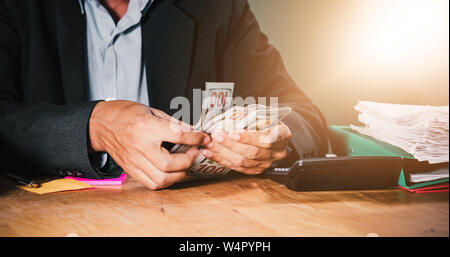 Businessmen count money and plan finances for projects and use calculators for analysis project documents and graph financial diagram working in the b Stock Photo