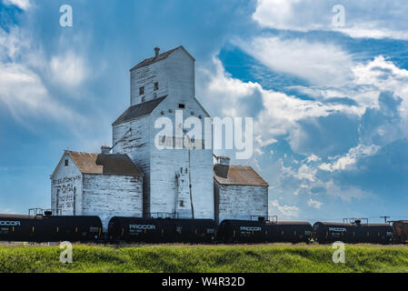 Pennant, SK/Canada- July 23, 2019: Storm clouds around the abandoned vintage grain elevator in Battrum, Saskatchewan Stock Photo