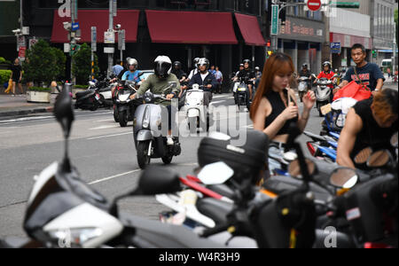 July 24, 2019, Taipei, Taiwan: A group of scooter riders can be seen at a local street near Taipei Main station. Taipei is the capital and a special municipality of Taiwan. Located in the northern part of the island of Taiwan. According to Wikipedia, the city is home to an estimated population of 2,704,810 people. In Taipei you can still see old structures and buildings, but the city also seems to be making very rapid progress in its modern infrastructure. Photograph taken on Wednesday, July 24, 2019. Photo by: Ramiro Agustin Vargas Tabares. (Credit Image: © Ramiro Agustin Vargas Tabares/ZUMA Stock Photo