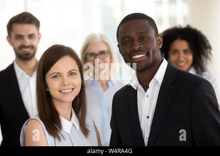 Head shot portrait of excited smiling diverse employees in office Stock Photo