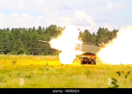 Soldiers from the Alpha Battery, 1-182 Field Artillery fires their High Mobility Artillery Rocket system during Northern Strike 2019 at Camp Grayling, Michigan, July 23, 2019. Northern Strike 19 is a National Guard Bureau-sponsored exercise uniting service members from more than 20 states, multiple service branches and numerous coalition countries. The exercise demonstrates the Michigan National Guard’s ability to provide accessible, readiness-building opportunities to achieve and sustain proficiency in conducting mission command, air, sea, and ground maneuver integration, with the synchroniza Stock Photo