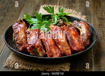Roasted pork ribs in frying pan Stock Photo