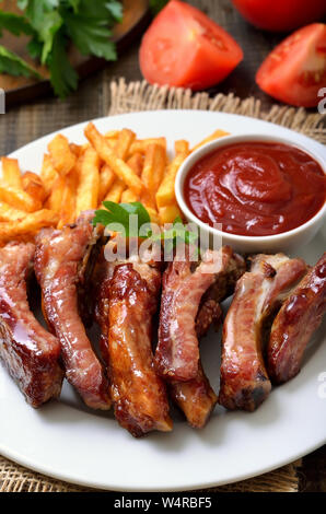 Roasted pork ribs and tomato sauce, close up view Stock Photo