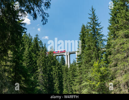 Langwies, GR / Switzerland - 24. July, 2015: the Rhaetian railway crosses the Langwies Viaduct over a deep canyon on the Chur - Arosa line Stock Photo