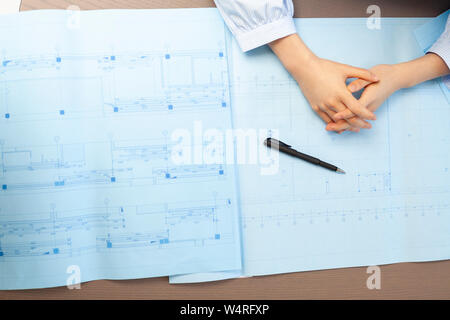 Blueprints and hands of female architect, Beijing, China Stock Photo