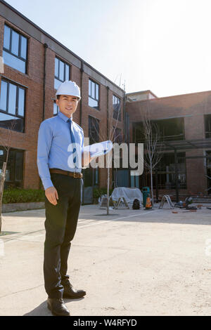 Portrait of male architect wearing safety helmet, Beijing, China Stock Photo
