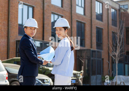 Two architects wearing safety helmets, Beijing, China Stock Photo