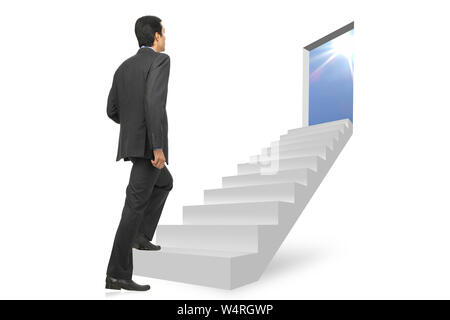 Businessman walking up on a staircase Stock Photo