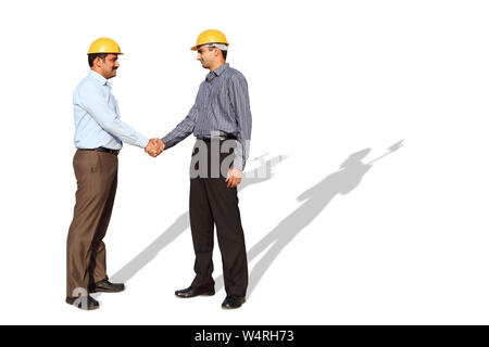 Two engineers shaking hands Stock Photo