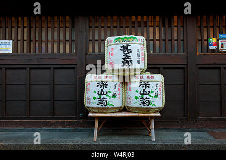 Bamboo table with three square cloth packages with Japanese letters on in front of shop, Hida-Takayama, Takayama Stock Photo