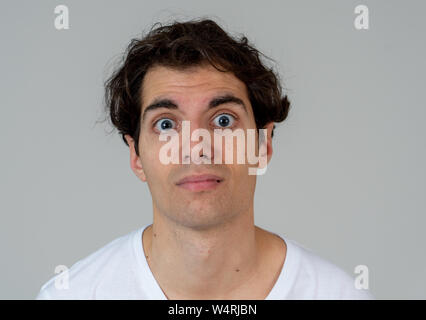 Young man feeling confused and displeased staring in disgust. Looking puzzled not understanding or liking something. Portrait with copy space. In Peop Stock Photo