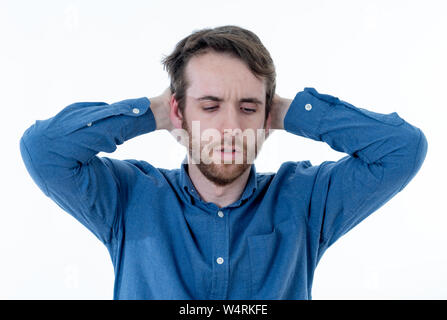 Young sad man suffering from depression. Worried and concerned hipster looking depressed and desperate feeling sorrow. Portrait with copy space. In Pe Stock Photo