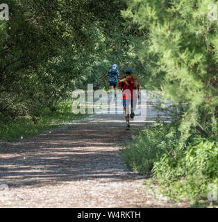 Two elderly man running in a forest in spring Stock Photo