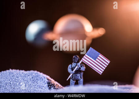 selective focus of toy astronaut holding american flag in space Stock Photo