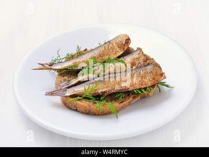 Sprats sandwiches on white plate Stock Photo