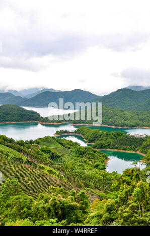 Vertical picture of stunning Taiwanese landscape by Thousand Island Lake and Pinglin Tea Plantations photographed in moody weather. Taiwan countryside. Oolong tea. China landscapes. Asia destinations. Stock Photo