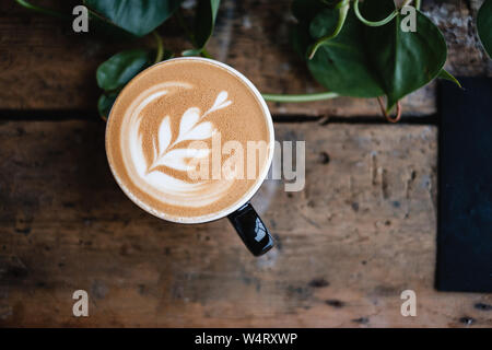 Overhead view of a latte coffee on a table Stock Photo