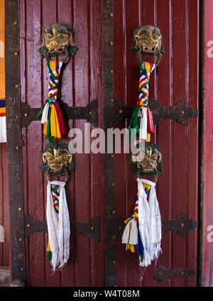 China, Tibet, Lhasa, Khatas or Tibetan prayer scarves and plaited tassels on the door handles at the entrance to the Norbulingka Palace grounds. The Norbulingka Palace was the summer palace of the Dalai Lama from about 1755 until 1959. It is part of the Historic Ensemble of the Potala Palace  a UNESCO World Heritage Site.