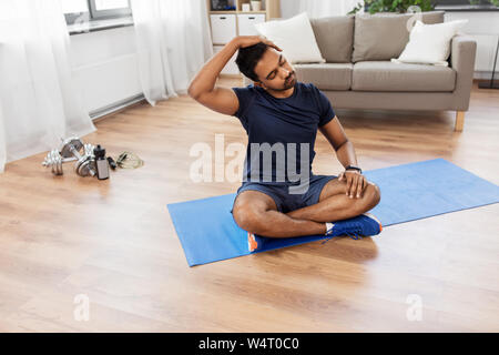 man training and stretching body at home Stock Photo