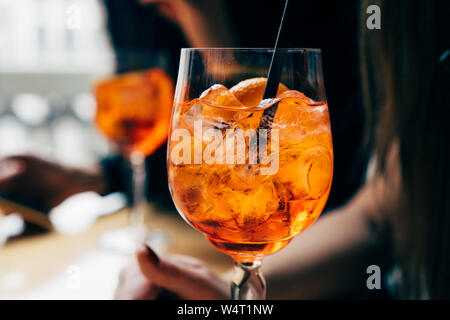 Two women with aperol spritz drinks