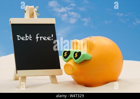 A successful piggybank giving financial planning advice with the words debt free written on a blackboard. Stock Photo