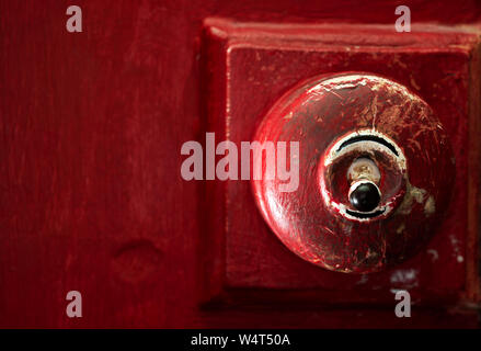 Old fashioned British interior round electric light switch Stock Photo