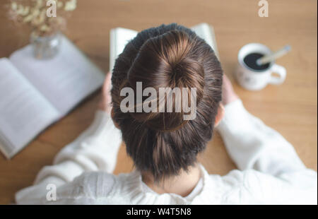 Overhead view of a teenage girl reading a book Stock Photo