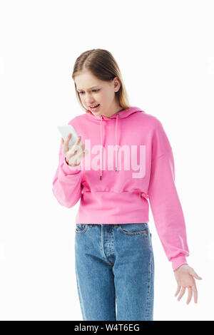 irritated teenage girl in pink hoodie and jeans holding smartphone isolated on white Stock Photo