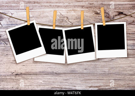 Photos on rope with clothespins on wooden background Stock Photo
