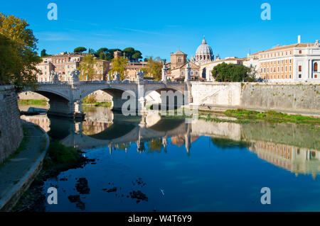 Image of Rione Ponte district. View of white Ponte Vittorio Emanuele II bridge, Vatican dome and their reflection, orange trees, waters of Tiber river Stock Photo