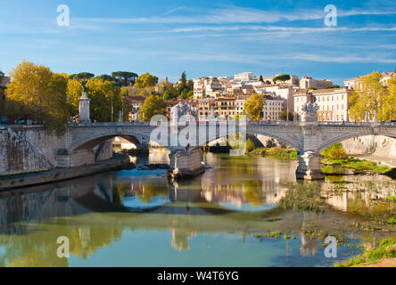 Image of Rione Ponte district. View of white Ponte Vittorio Emanuele II bridge, Vatican dome and their reflection, orange trees, waters of Tiber river Stock Photo