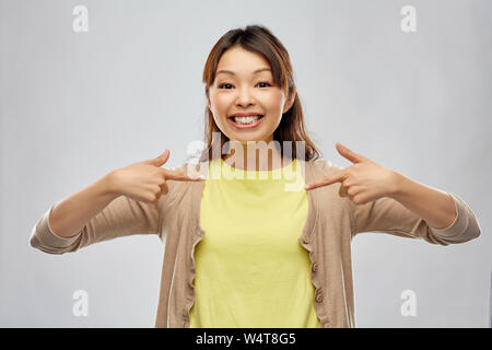 happy asian woman over grey background Stock Photo