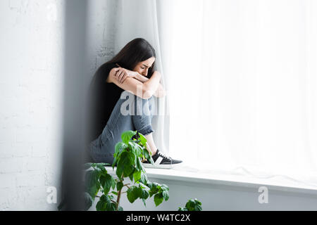 sad depressed young woman hiding her face 19577262 Stock Photo at