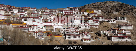 China, Tibet, Lhasa, The Ganden Monastery sits at the top of a natural amphitheater on Wangbur Mountain. It  founded in 1409 AD but was mostly destroyed in 1959 by the Chinese military  The Serdung Lhakhang is the large red building  with the white Tsokchen Hall immediately to its right. Stock Photo