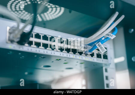 Ethernet cables and Network switch in data center. Wifi plug of internet router for computer. Network hub. Checkpoint equipment for data security. Stock Photo