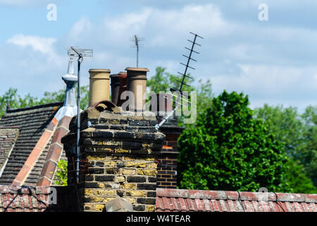 Typical English chimneys on the roofs of London buildings, an element of architecture Stock Photo