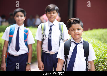Portrait of schoolboys standing at school campus Stock Photo