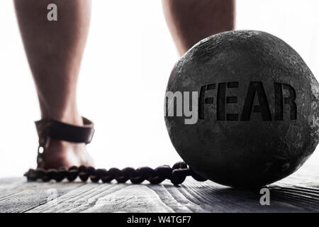 Fear is ball on the leg. Concept of fear. Stock Photo