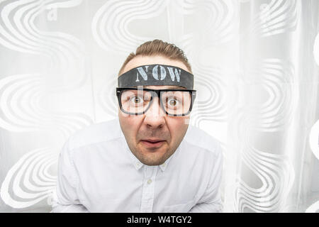 A frightened and surprised man has to do things right now and he does not have time for it. He says he does not have time. Do it now, stop time concep Stock Photo
