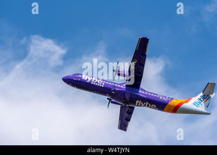 Flybe ATR 72 turboprop airliner plane EI-FMJ taking off from London Southend Airport, Essex, UK. Purple airline livery Stock Photo
