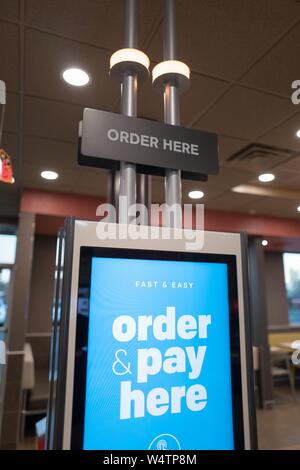 Automated touch screen ordering system at McDonald's fast food restaurant in Santa Nella, California, allowing visitors to place their order and receive their food via a large touch screen interface, October 24, 2018. () Stock Photo