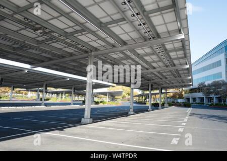 View from below of a large carport or parking lot solar panel array, a common method for generating renewable energy, at an office park in the Silicon Valley town of Sunnyvale, California, October 28, 2018. () Stock Photo