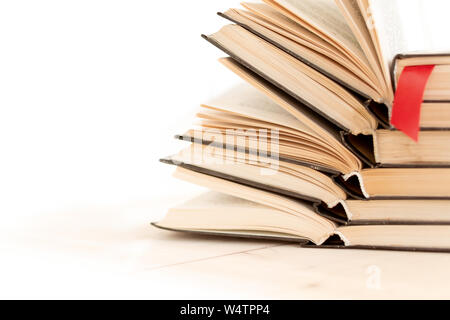 Heap pile of rare books. Open book, hardback books on wooden table. Education background. Back to school. Copy space for text. Bestseller, business. S Stock Photo