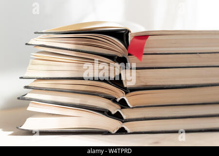 Heap pile of rare books. Open book, hardback books on wooden table. Education background. Back to school. Copy space for text. Bestseller, business. S Stock Photo