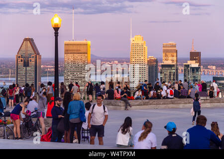 Montreal, CA - 24 July 2019: Tourists enjoying view of Montreal skyline from Kondiaronk Belvedere in summer at sunset. Stock Photo